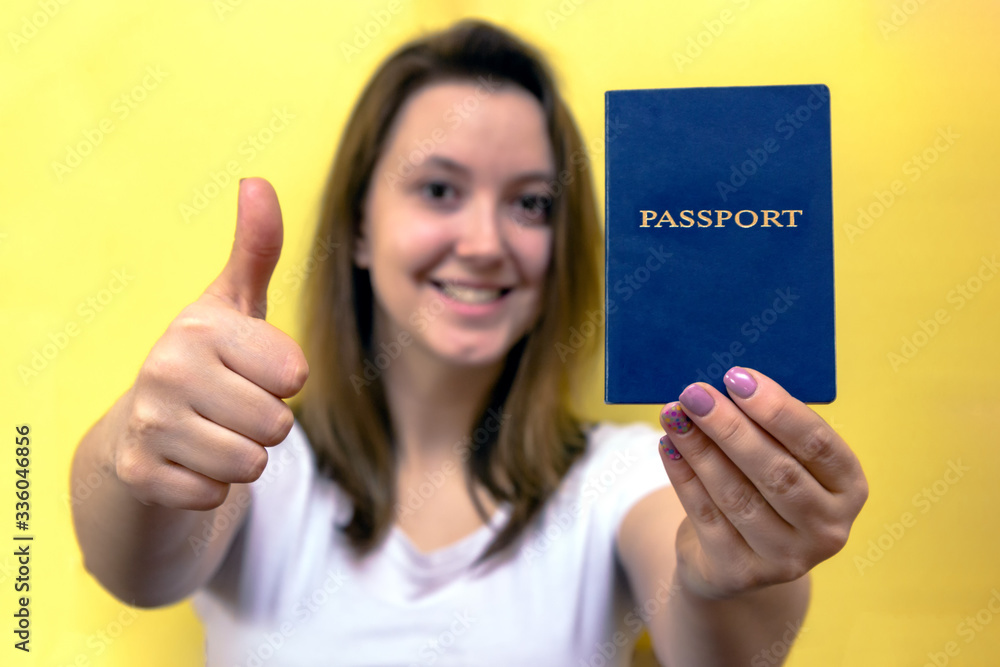 tourist woman holding passport id happy with thumb up with fingers