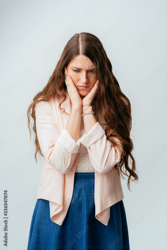 on a gray background young girl sad on a gray background young girl sad