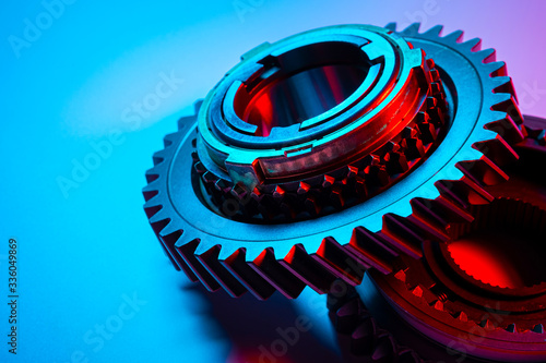 New metal gears spare parts for gearbox in two colors red and blue. Conceptual image of the mechanical elements of the transmission