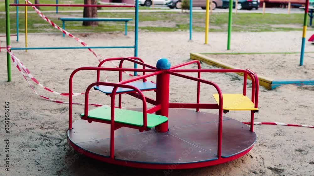 An empty abandoned playground fenced with ribbons in a residential area during quarantine due to the threat of AKA covid-19 coronavirus. Ukraine, Sumy An empty abandoned playground fenced with ribbons in a residential area during quarantine due to the threat of AKA covid-19 coronavirus. Ukraine, Sumy