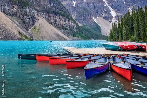 Corlorful canoes on Moraine lake near Lake Louise village in Banff National Park, Alberta, Rocky Mountains, Canada