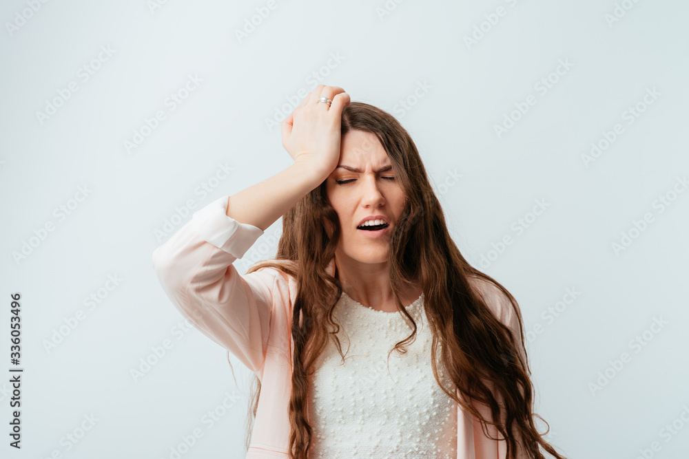 long-haired beautiful young brunette woman headache and holding on to the left side of the head long-haired beautiful young brunette woman headache and holding on to the left side of the head
