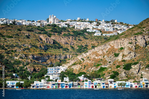 Klima and Plaka villages with whitewhashed traditional houses and orthodox church and windmills on Milos island, Greece photo