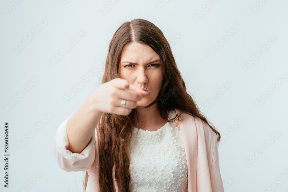 on a gray background young girl shows on you on a gray background young girl shows on you