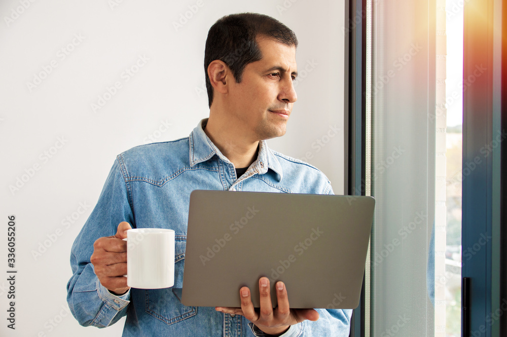 Man working online at home on a laptop Man working online at home on a laptop