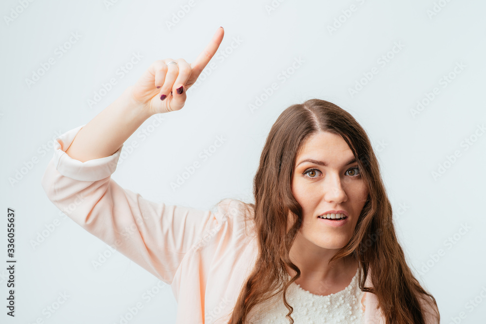 Fototapeta premium Young girl shows the index finger up