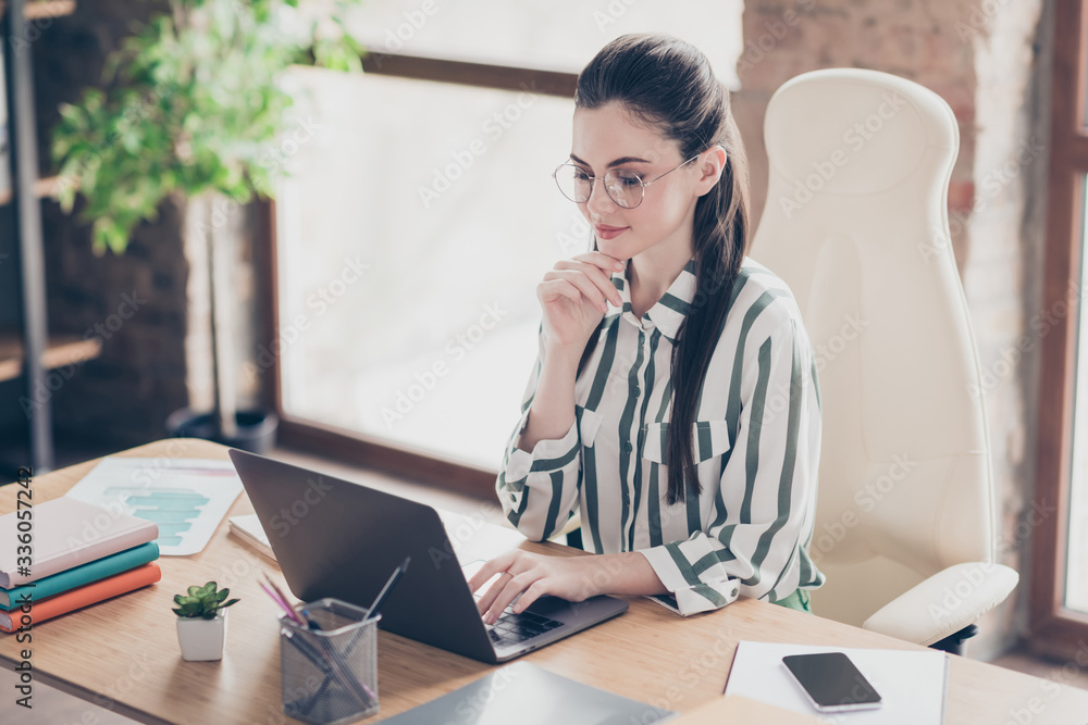 Portrait of focused intelligent start up expert girl sit table work laptop read coworkers report watch workshop seminar in workplace workstation Portrait of focused intelligent start up expert girl sit table work laptop read coworkers report watch workshop seminar in workplace workstation