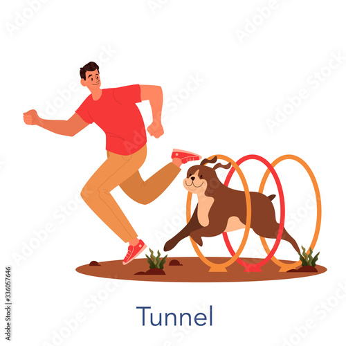 Dog agility tunel. Training exercise for pet. Man training his pet dog.