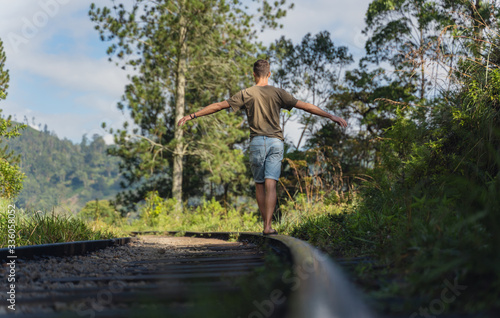 young man are walking on the tracks in Ella. Sri Lanka