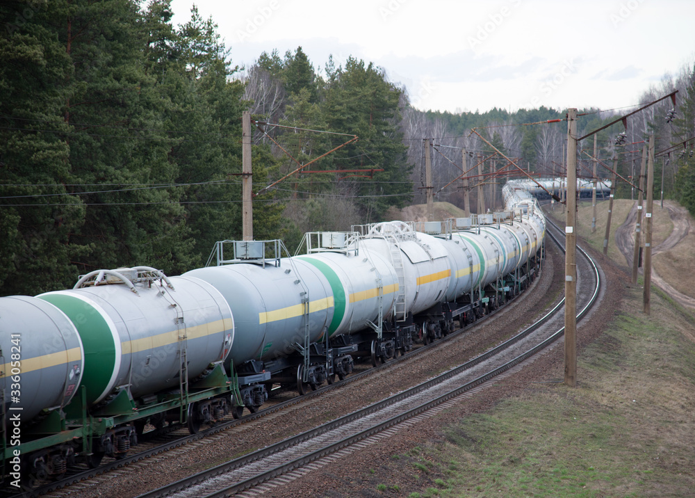 Freight train with petroleum tank cars on railroad. Rail cars carry oil