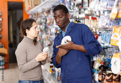 Modern salesman offering tools to young woman