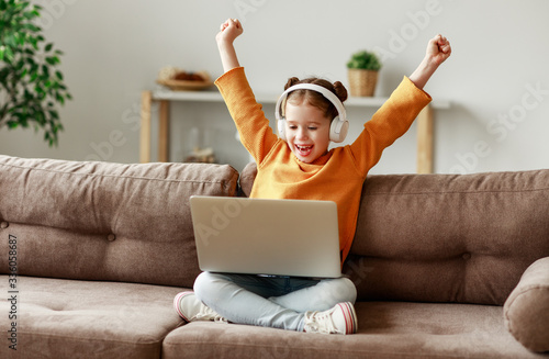 Girl celebrating victory in video game. photo