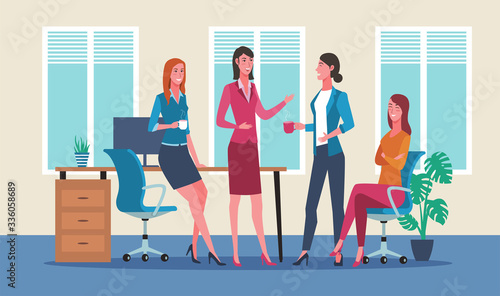 Group of business women chatting during coffee break in office
