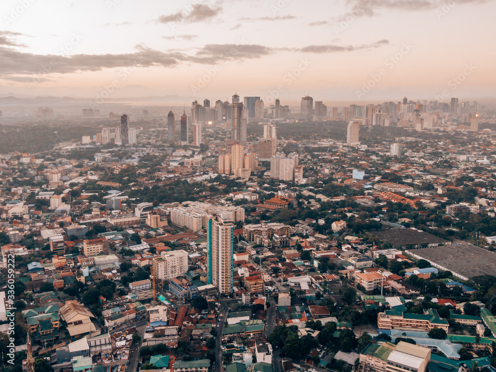 Aerial drone shot of Makati City while sunrise