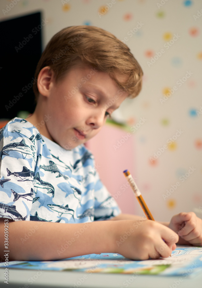 Child with homework during online lesson at home, social distance during quarantine Covid-19 Child with homework during online lesson at home, social distance during quarantine Covid-19