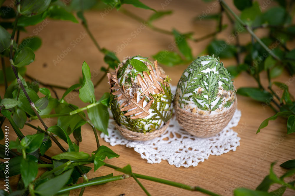 Forest themed Easter eggs decorated with natural leafs – holiday table decoration during celebration - obrazy, fototapety, plakaty 