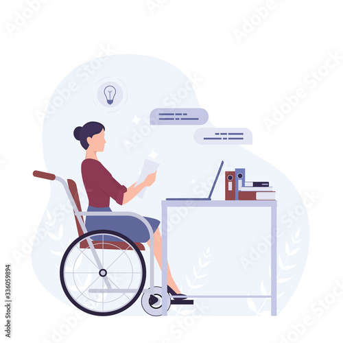 Disabled young woman in wheelchair working in office.