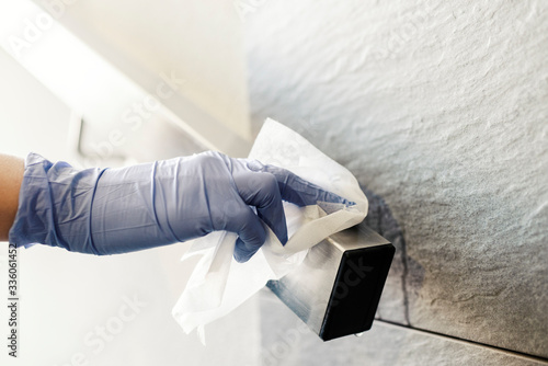 Photography Disinfecting a bannister during the coronavirus with alcohol wipe