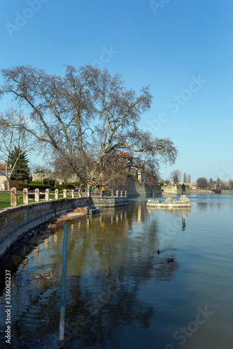 The old lake in Tata, Hungary with the statue of Saint John.