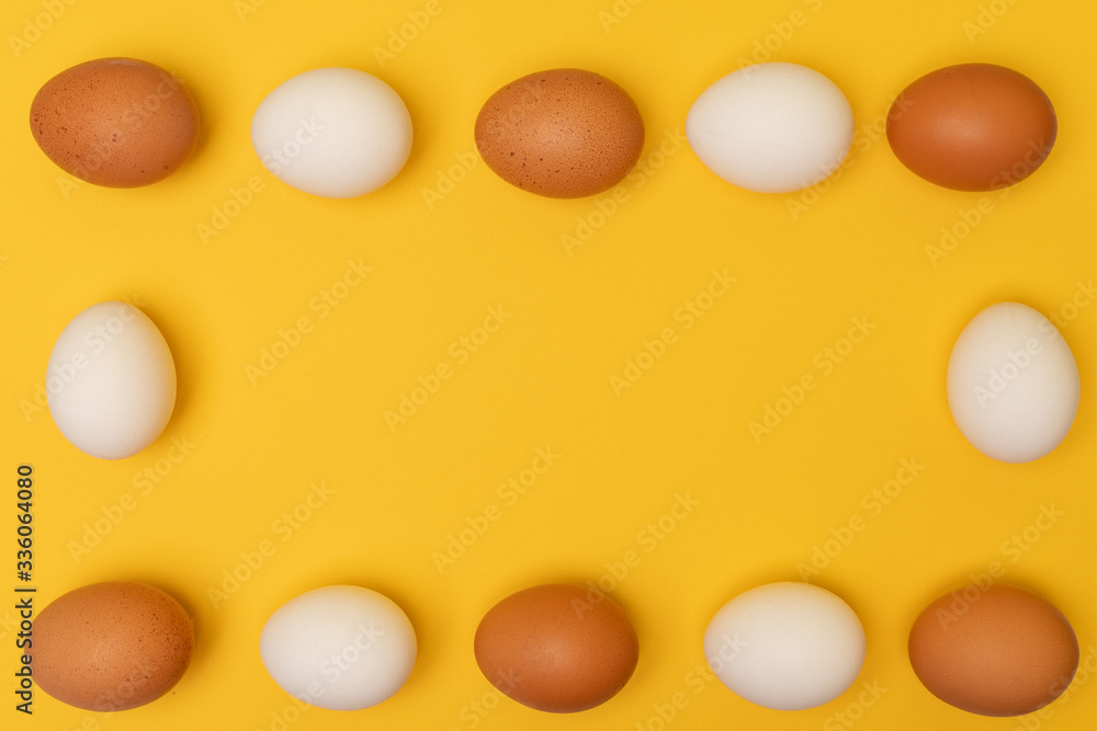 Easter eggs on a yellow background, place for an inscription in the center Easter eggs on a yellow background, place for an inscription in the center