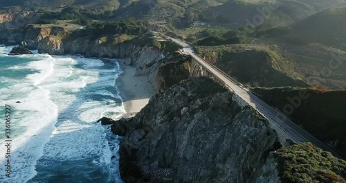 Aerial view, Bixby Creek Bridge, Scenic view of Cross Canyon Bright Sun rise in the background.