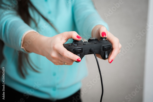 Happy young beautiful woman playing a video game