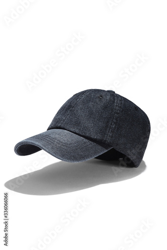 Subject shot of a black denim baseball cap with a stitch on the visor and vent holes. The unisex headwear is isolated on the white background.