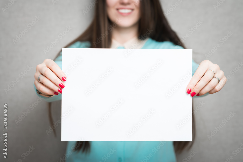Banner sign woman peeking over edge of blank empty paper billboard with copy space for text. Beautiful Asian Caucasian woman looking surprised and scared - funny. Isolated on white background. Banner sign woman peeking over edge of blank empty paper billboard with copy space for text. Beautiful Asian Caucasian woman looking surprised and scared - funny. Isolated on white background.