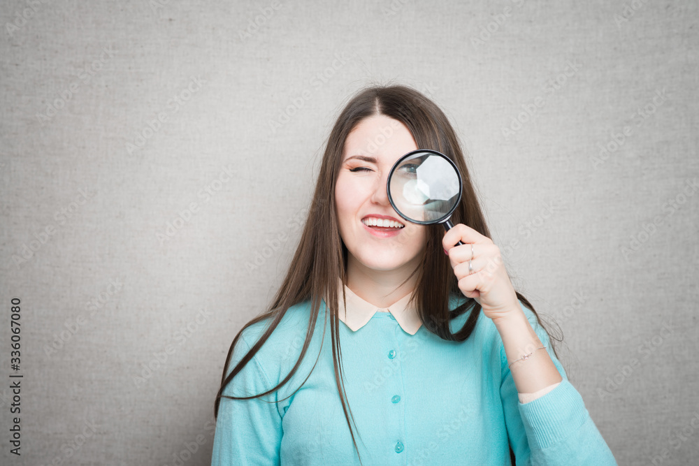 Young beautiful woman with magnifying glass. Young beautiful woman with magnifying glass.