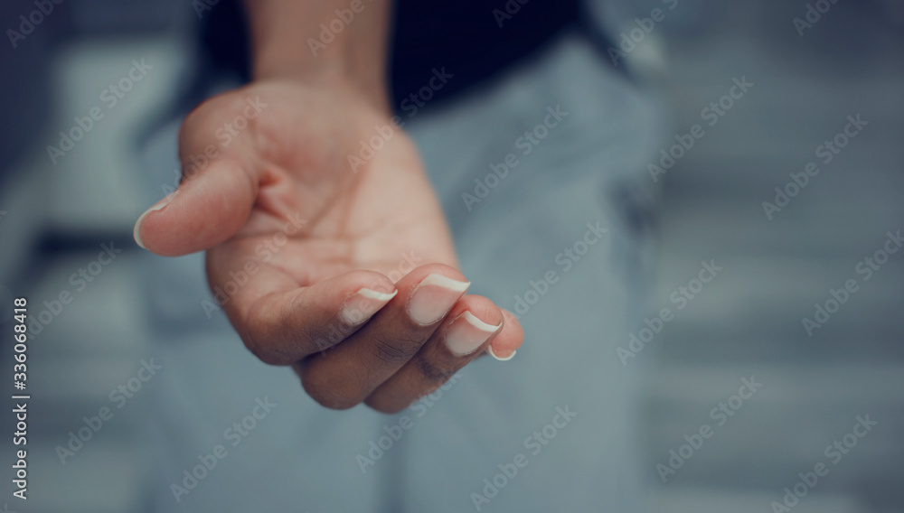 Black woman offering a helping hand. Closeup and selective focus on her fingers. Black woman offering a helping hand. Closeup and selective focus on her fingers.