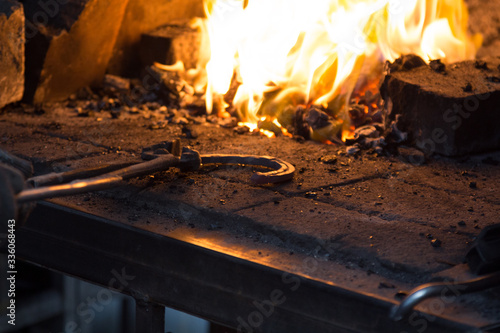 Making the horseshoe from heated red rod