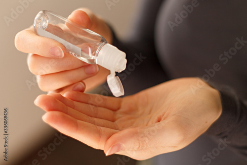 close-up of antiseptic in a bottle being poured on your hands.