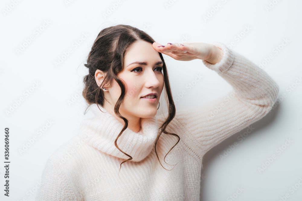 Woman with hand on forehead looking into distance Woman with hand on forehead looking into distance