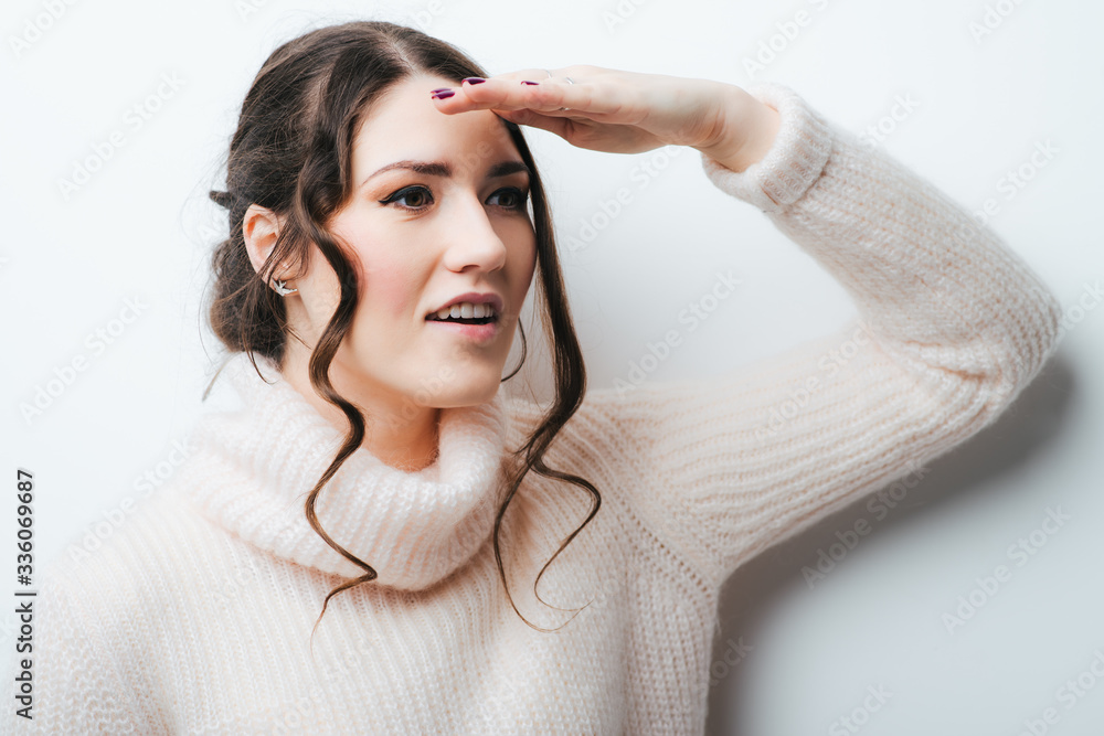 Woman with hand on forehead looking into distance Woman with hand on forehead looking into distance