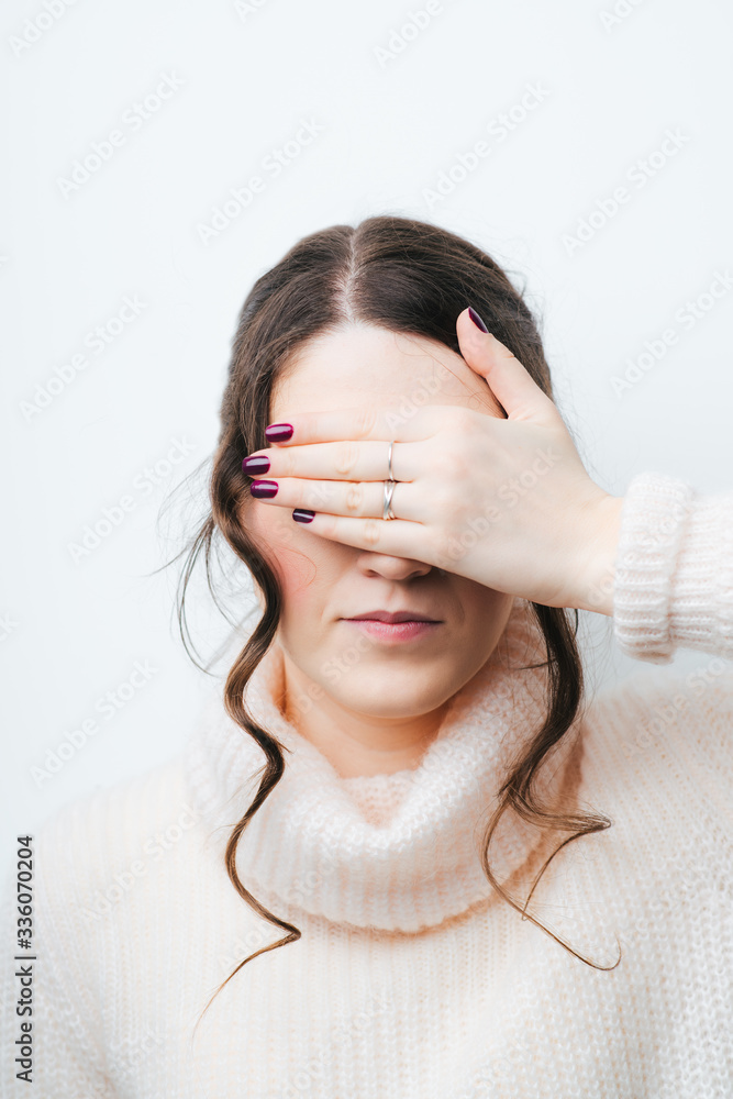 Businesswoman covering her eyes