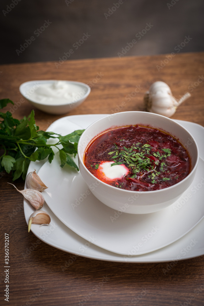 Red borscht soup with dill in white bowl. Red borscht soup with dill in white bowl.