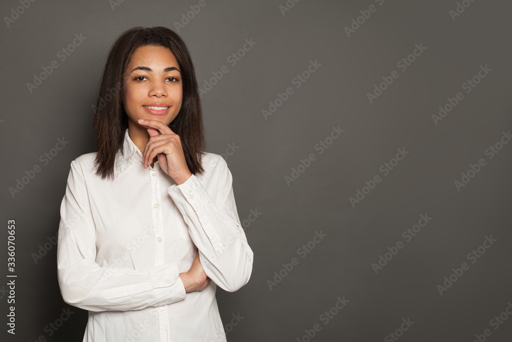 Clever woman thinking and smiling on dark background Clever woman thinking and smiling on dark background