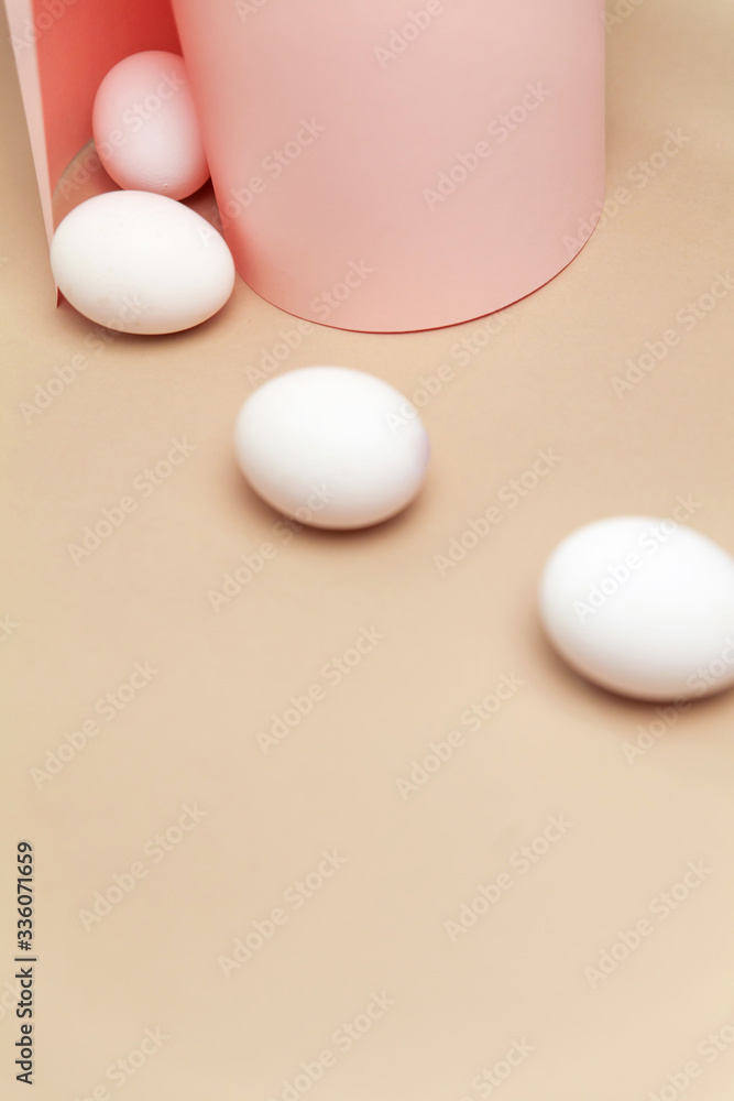 Creative Easter beige and pink background with white eggs. Creative Easter beige and pink background with white eggs.