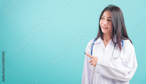 doctor, happy beautiful young woman in uniform standing, smiling, point finger