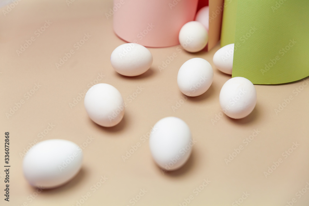 Creative Easter beige and pink background with white eggs. Creative Easter beige and pink background with white eggs.
