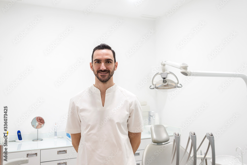 Portrait of a smiling doctor male posing in an dentist office Portrait of a smiling doctor male posing in an dentist office