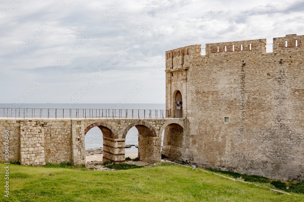 The viaduct bridge to the Castello Maniace citadel in Siracusa, Sicily, Italy in a sunny day with clouds