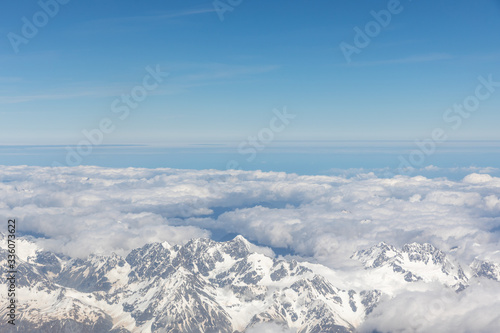 Aerial view of snow capped mountains and blue skies in New Zealand