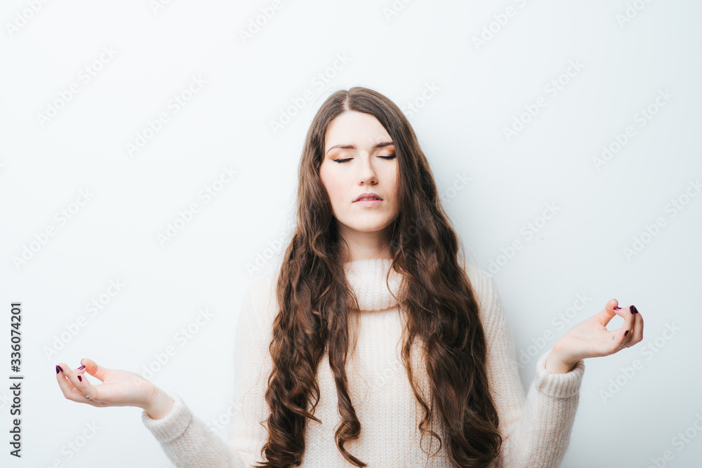 on a white background young girl with long hair meditating on a white background young girl with long hair meditating