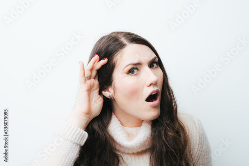 beautiful long-haired girl overhears on a white background
