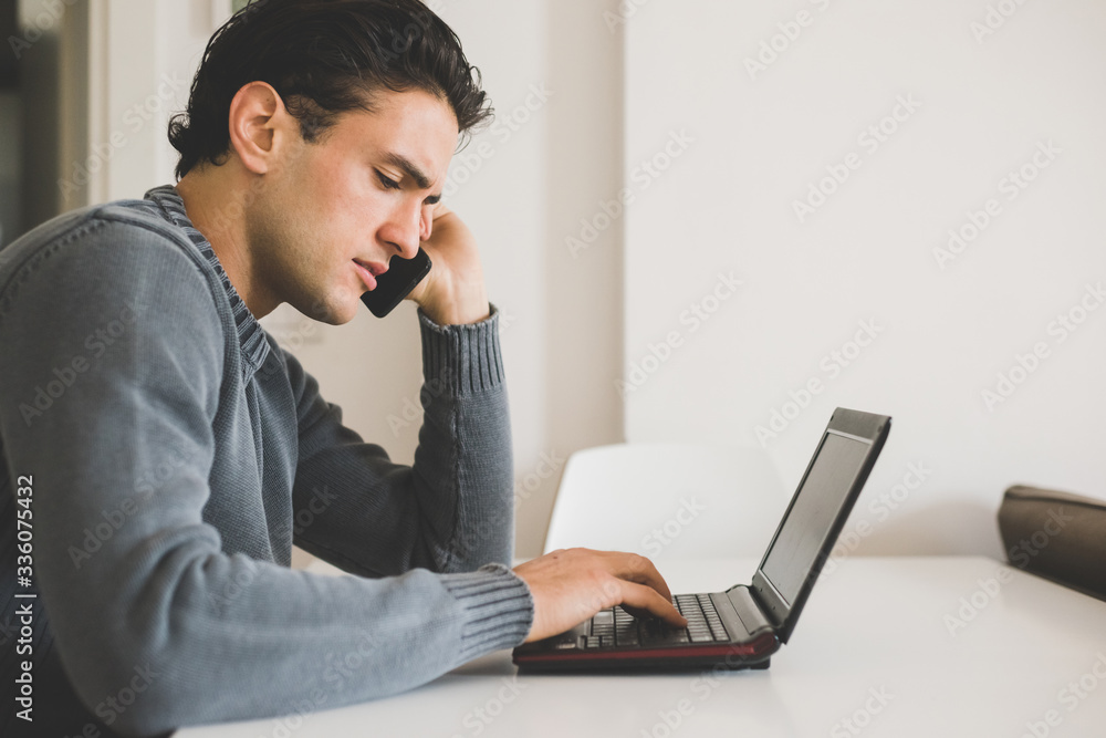 Young woman self isolation working from home telehpne call using computer Young woman self isolation working from home telehpne call using computer