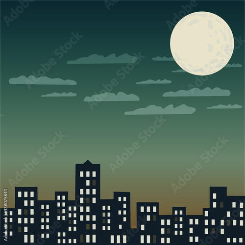 A large moon behind the clouds shines over the evening city when light is burning in the houses