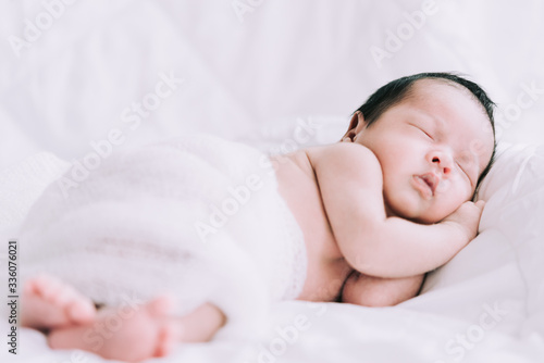 Smiling baby boy lying on a white bed, Family morning at home,Children hygiene.