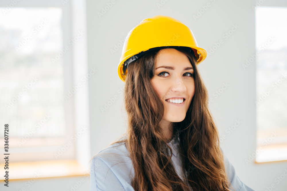 girl in yellow helmet near a large window girl in yellow helmet near a large window