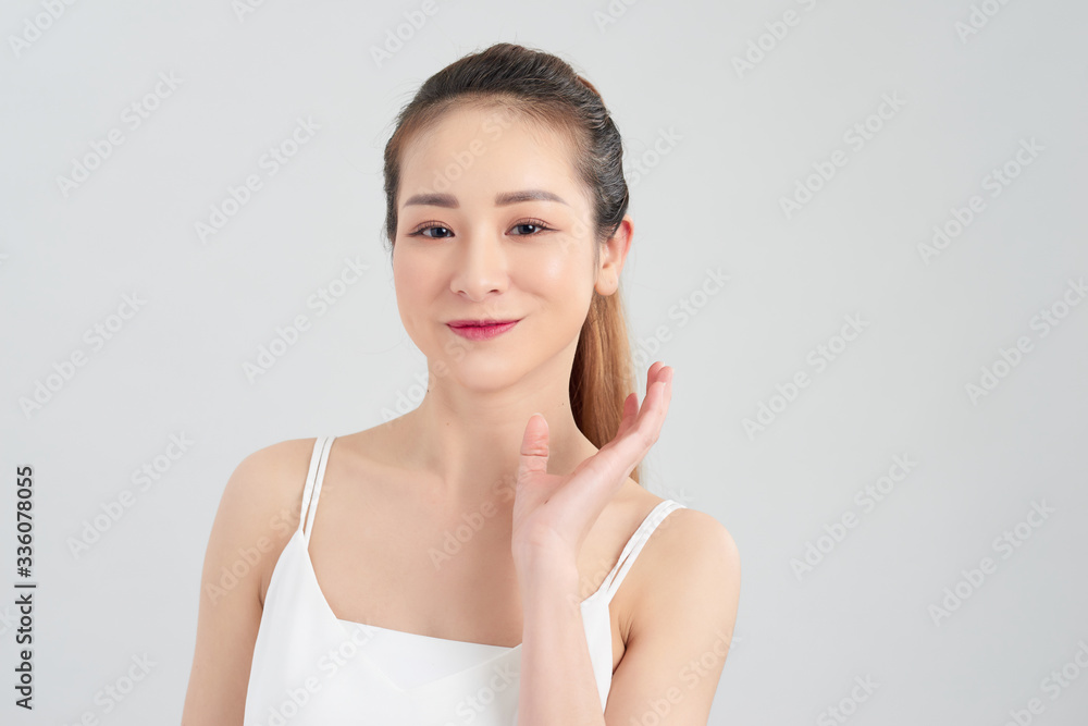 Portrait of beautiful young Asian woman over white background. Portrait of beautiful young Asian woman over white background.